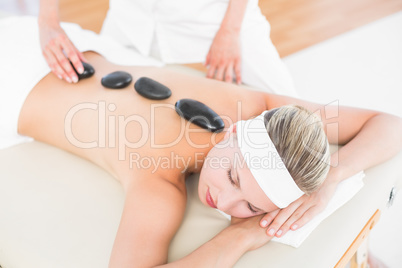 Beautiful blonde enjoying a hot stone massage