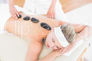 Beautiful blonde enjoying a hot stone massage