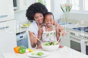 Mother and daughter making a salad together