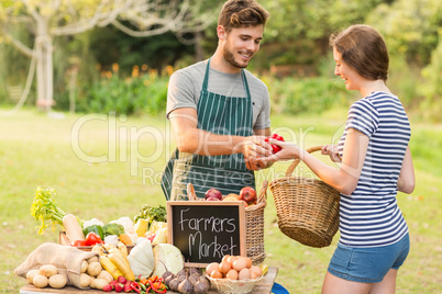 Brunette buying peppers at the farmers market