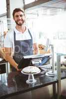 Smiling worker posing behind the counter