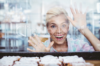 Astonished pretty woman looking at cup cakes