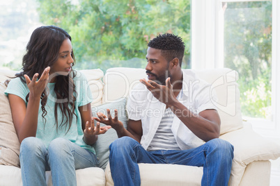 Couple having argument on the couch Couple having argument on the couch
