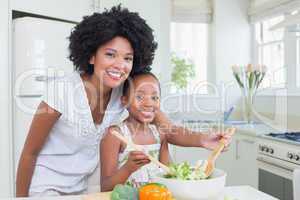 Mother and daughter making a salad together