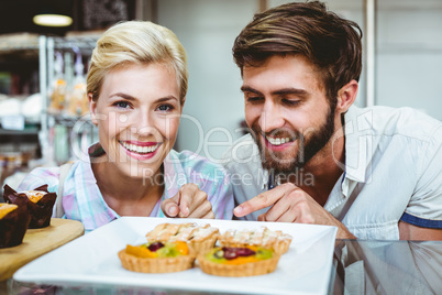 Cute couple on a date pointing fruit pie