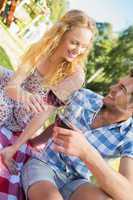 Young couple on a picnic drinking wine