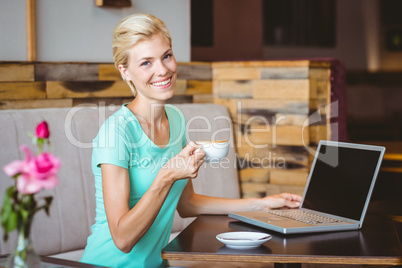 Pretty blonde holding cup of coffee