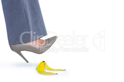 Woman with heel shoes walking on banana