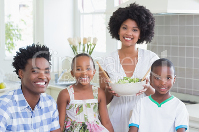 Happy family sitting down to dinner together