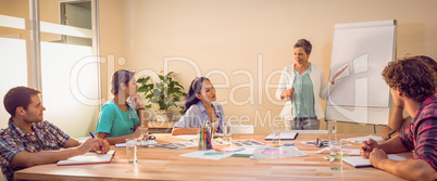 Casual businesswoman giving presentation to her colleagues