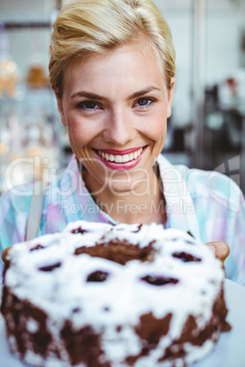 Pretty woman looking at a chocolate cake