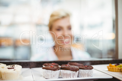 Pretty woman looking at cup cakes