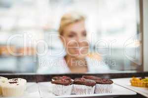 Pretty woman looking at cup cakes