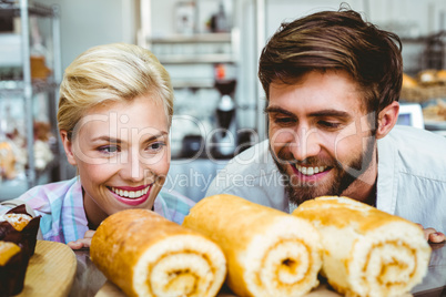 Cute couple on a date looking at cakes