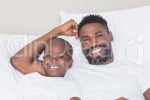 Father and son smiling at camera