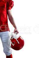 An american football player taking his helmet on hand