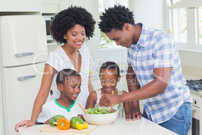 Happy family preparing vegetables together