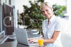 Happy pretty woman using her laptop computer