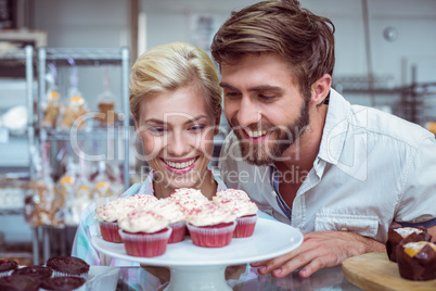 Cute couple on a date looking at cakes