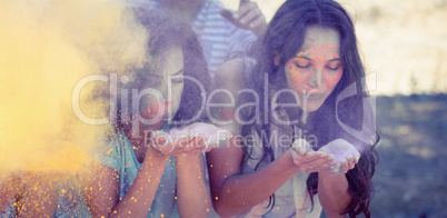 Young women having fun with powder paint