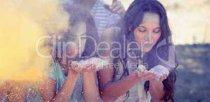 Young women having fun with powder paint