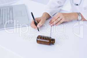 Doctor writing on a notepad