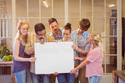 Creative business team holding cardboard written