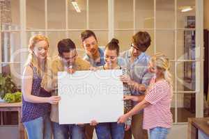 Creative business team holding cardboard written