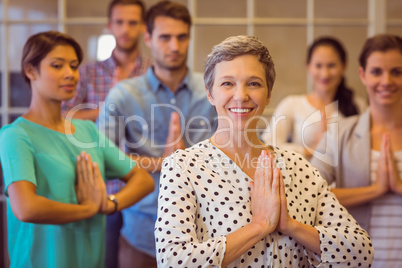 Creative businesswoman praying with her team work