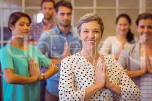 Creative businesswoman praying with her team work