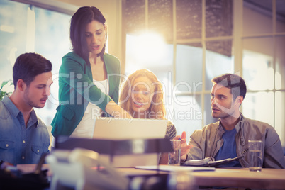 Group of young colleagues using laptop