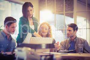 Group of young colleagues using laptop