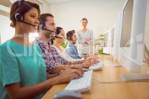 Manager supervising work in call center