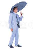 Businessman sheltering under umbrella