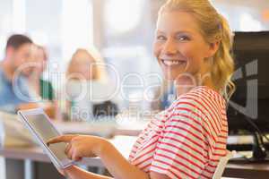 smiling young women using digital tablet