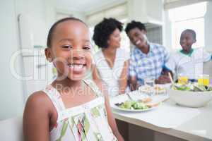 Happy family sitting down to dinner together