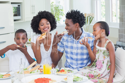 Happy family sitting down to dinner together