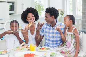 Happy family sitting down to dinner together