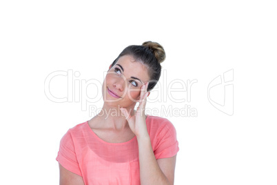 Thoughtful pretty casual brunette standing with hand on head