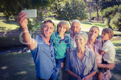 Happy family taking a selfie in the park