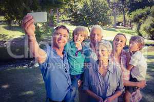 Happy family taking a selfie in the park