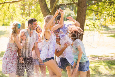 Young friends having fun with hose in the park