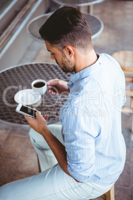 Attentive businessman sending text message