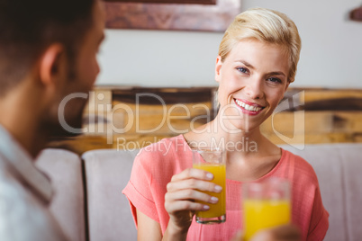 Pretty blonde holding a glass of orange juice