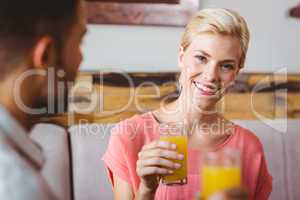 Pretty blonde holding a glass of orange juice