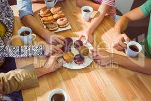 Business people taking cakes on table