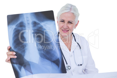 Serious smiling doctor looking at x-ray