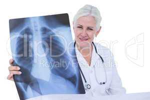 Serious smiling doctor looking at x-ray