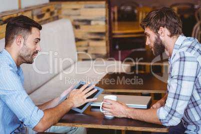 Business team looking at tablet