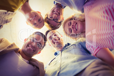 Business team standing in circle smiling at camera